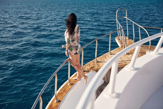 Mature woman standing on the yacht and enjoying her vacation on the sea.