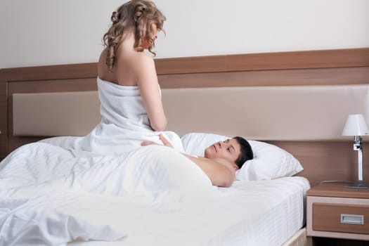 Portrait of young couple making love in bed