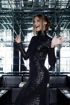 Full length portrait of happy young woman smile in long black dress