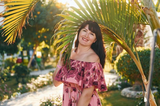 Happy mature woman is outdoors enjoying her vacation at sunny daytime.