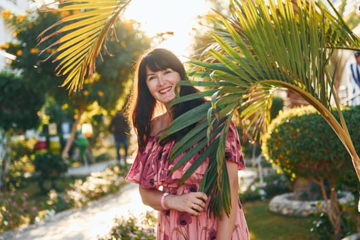 Happy mature woman is outdoors enjoying her vacation at sunny daytime.