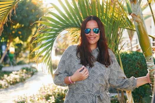 Happy mature woman is outdoors enjoying her vacation at sunny daytime.