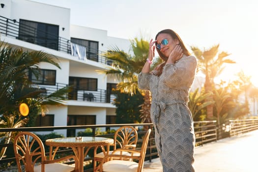 Happy mature woman is outdoors enjoying her vacation at sunny daytime.