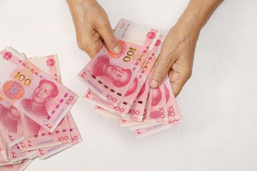 Chinese Senior woman counting money for payment