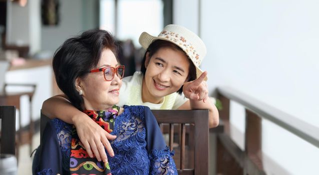 Senior asian woman with daughter relaxing on vacation together.