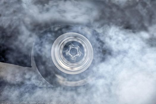 Drag racing car burns rubber off its tires in preparation for the race
