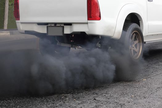 Air pollution from vehicle exhaust pipe on road