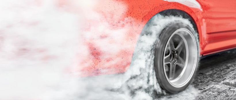 Drag racing car burns rubber off its tires in preparation for the race