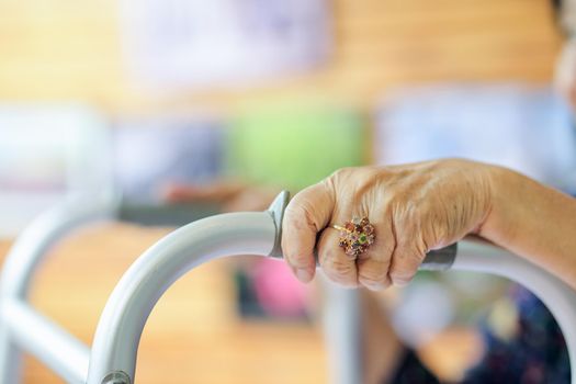 Elderly asian woman using a walker in restaurant