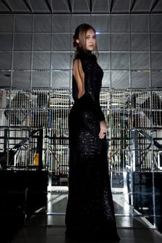 Gorgeous tall girl posing in black cocktail dress