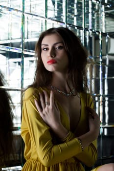Portrait of beautiful brunette woman near mirror