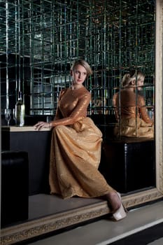 Full length portrait of woman sitting on sofa in club