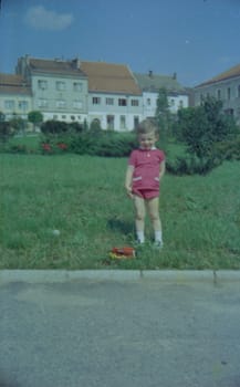 THE CZECHOSLOVAK SOCIALIST REPUBLIC - 1973: Retro photo shows boy with toy outdoors.