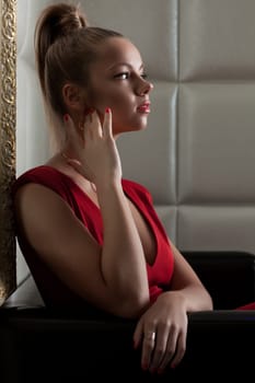 Portrait of young woman sitting on sofa in club