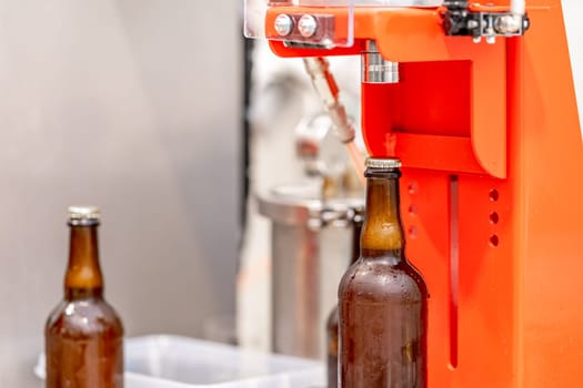 capping beer bottles in a brewery.