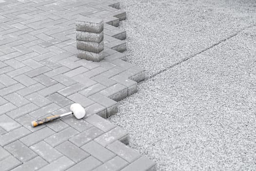 rubber hammer for adjusting the lock paving on the sidewalk. High quality photo