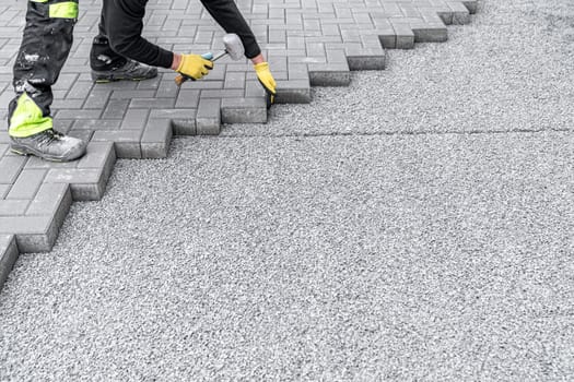 rubber hammer for adjusting the lock paving on the sidewalk. High quality photo