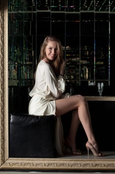 Portrait of beautiful young woman in nightclub - white fashion dress