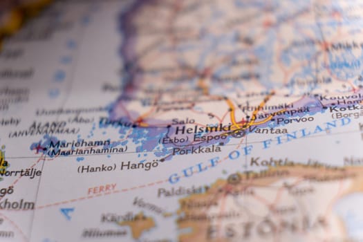 Close up detail of a colorful map focusing on Helsinki, Finland through selective focus, background blur.