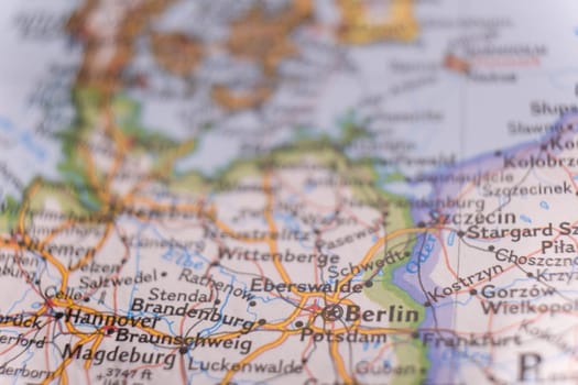 Close up of a colorful map focusing on Berlin, Germany through selective focus, background blur.