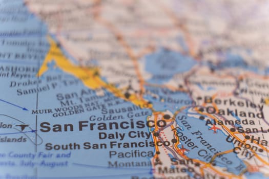 Close up detail of a colorful map focusing on San Francisco, California through selective focus, background blur.