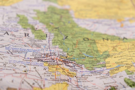 Close up detail of a colorful map focusing on Phoenix Arizona through selective focus, background blur.