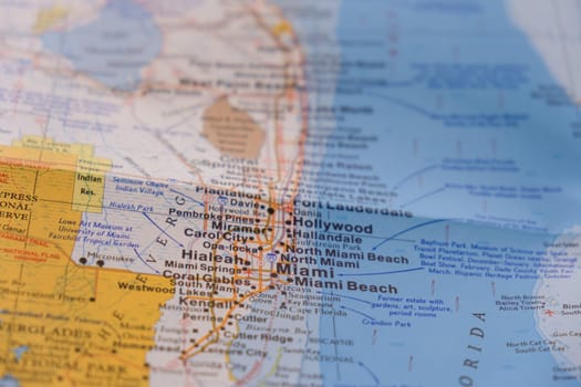 Close up detail of colorful map highlighting Miami, Florida through selective focus, background blur. High quality photo