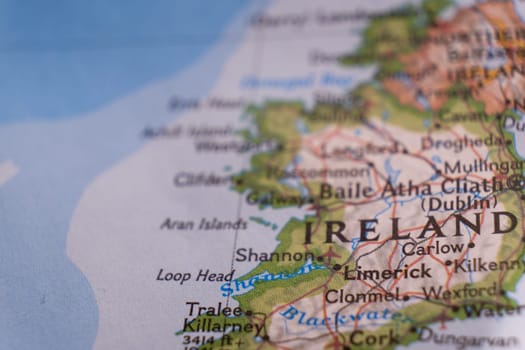Close up of a colorful map focusing on Limerick, Ireland through selective focus, background blur.