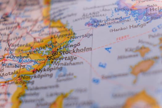 Close up of a colorful map focusing on Stockholm, Sweden through selective focus, background blur.