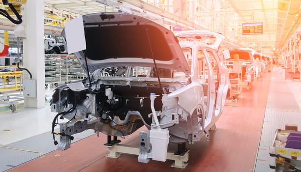 Photo of automobile production line. Modern car assembly plant. Modern and high-tech automotive industry. Conveyor of auto bodies