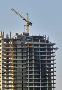 view of a construction site and a working crane working in a new construction business.