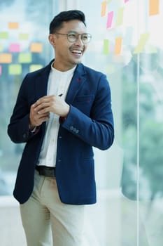 Male entrepreneur, business owner or Asian male businessman standing at a meeting with smiling faces from work.