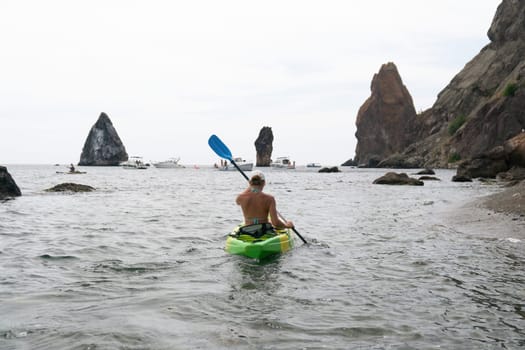 Kayaking. Travel adventure kayak on the tropical sea on a sunny day. Woman rowing a canoe.