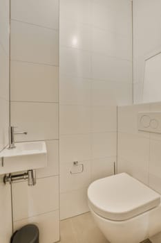 a bathroom with white tiles on the walls, and a black toilet in the corner next to it is a mirror