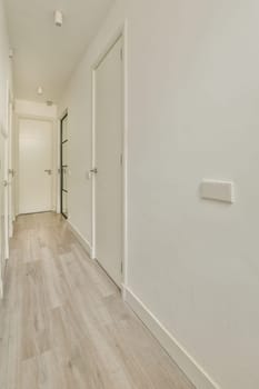 an empty room with white walls and wood flooring on the left side of the room, there is a door to the right