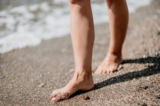 Barefoot woman standing in sea, summer vacation on beach resort. Naked female legs in transparent calm water