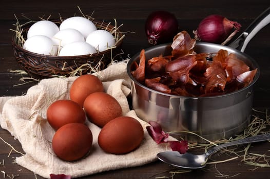 Coloring chicken eggs for Easter with onion peel. Easter, Sunday. Healthy food. Dark key, rustic. Selective focus.