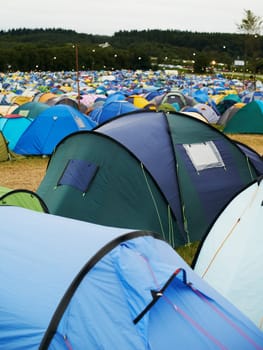 Full house at the festival. Landscape shot of tents on a field at an outdoor festival