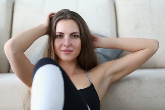 Portrait of beautiful young woman in sportswear at home. Home fitness sport and health concept