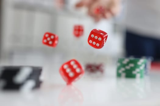Person rolls dice and chips. Casino game and luck concept