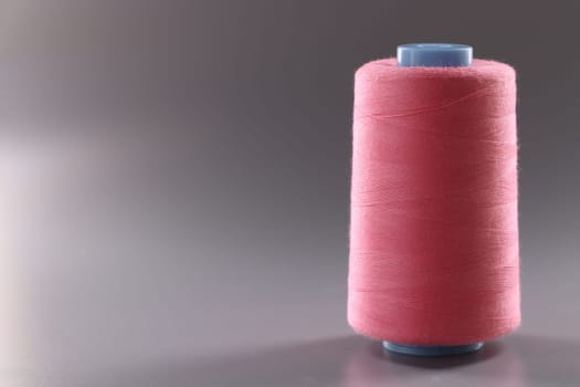 Threads of light pink color in coil. Choice of threads for sewing machine concept