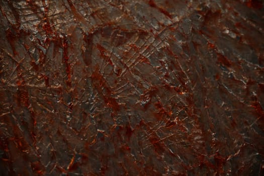 Cracked glass with blood drops or paint closeup. Broken glass texture with red drops background