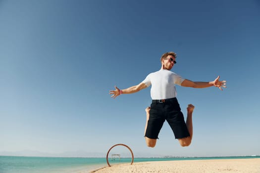 Having fun. Young european man have vacation and enjoying free time on the beach of sea.