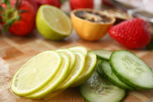 Sliced vegetables and fruits on wooden board. Benefits of vegetarian food and health concept