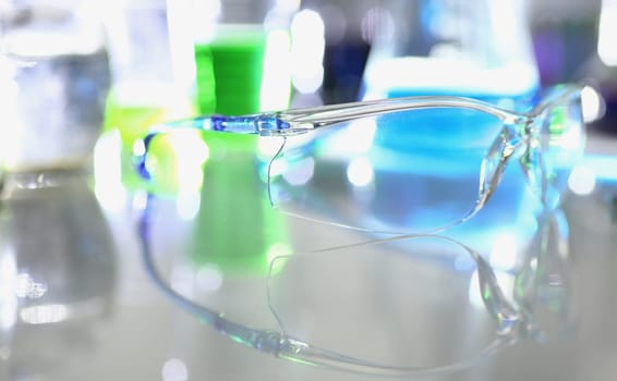 Transparent glasses and chemical liquids in test tubes in laboratory. Research toxic and poisonous solvents concept