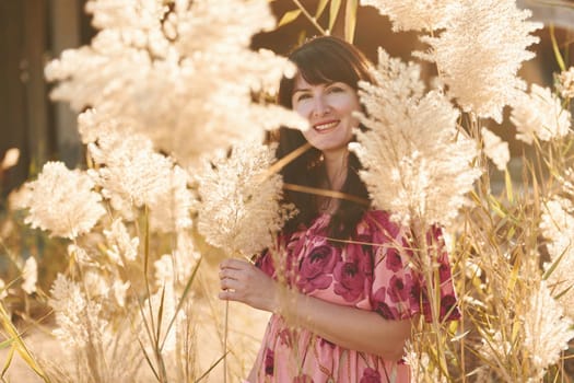 Happy mature woman is outdoors enjoying her vacation at sunny daytime.