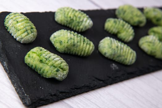 Pile of green spinach gnocchi, potato peru italian food, Homemade, High quality photo