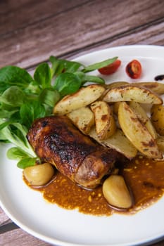 Recipe for boneless rolled chicken leg with potatoes and molasses-flavoured mache salad, High quality photo