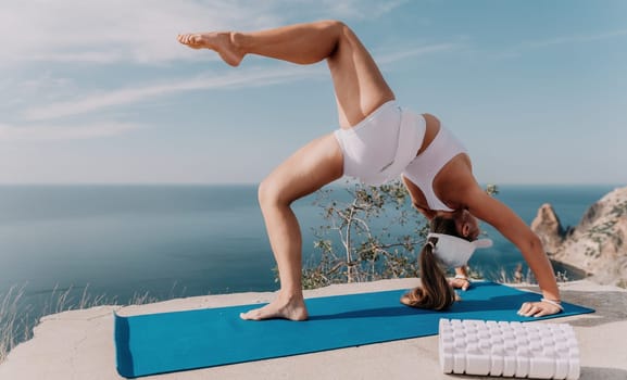 Fitness woman sea. Outdoor workout with fitness rubber bands in park over beach. Female fitness pilates yoga routine concept. Healthy lifestyle. Happy fit woman exercising with rubber band in park