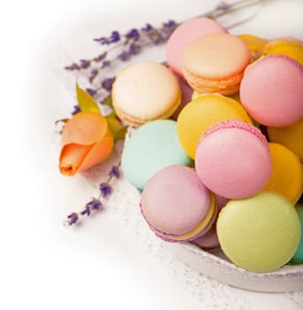 Colorful macaroons in a gift box on a white table
